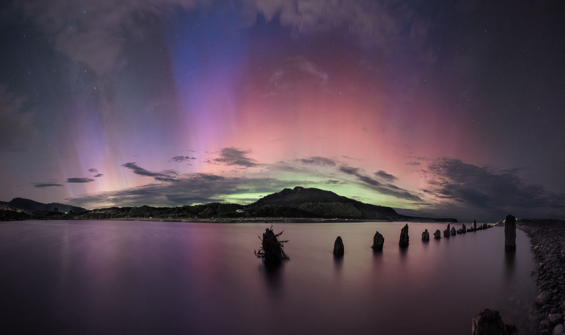 Aurora australis with Tall Blue Rays over Rapahoe pier stumps